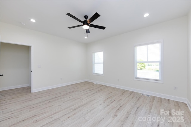 spare room featuring a ceiling fan, visible vents, baseboards, light wood-style floors, and recessed lighting