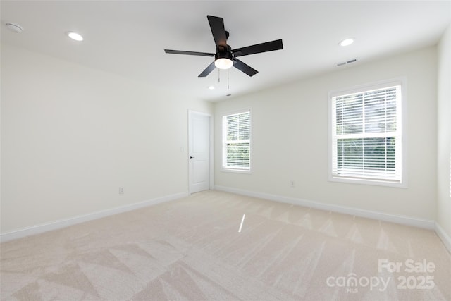 unfurnished room with a ceiling fan, visible vents, baseboards, light carpet, and recessed lighting