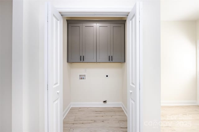 washroom featuring baseboards, hookup for a washing machine, light wood-style floors, cabinet space, and electric dryer hookup