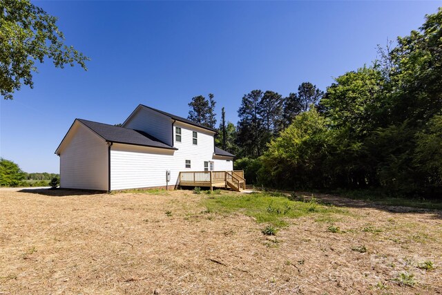 rear view of property with a wooden deck