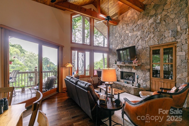 living room with a fireplace, hardwood / wood-style floors, wood ceiling, and beamed ceiling