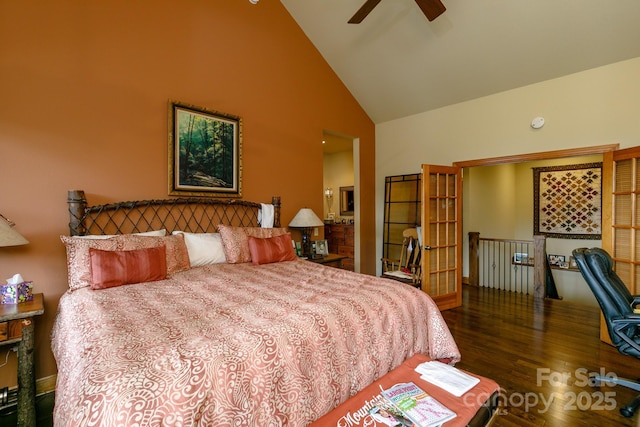 bedroom featuring high vaulted ceiling and wood finished floors