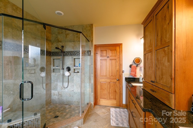 bathroom featuring a shower stall and vanity