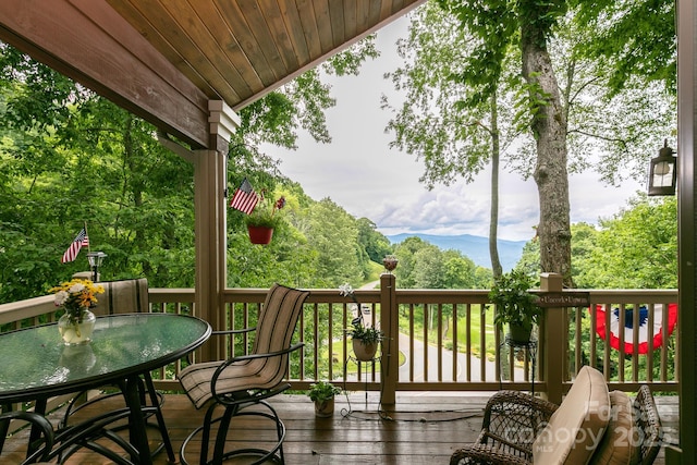 wooden terrace featuring outdoor dining space