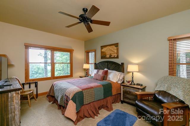 bedroom with baseboards, a ceiling fan, and carpet