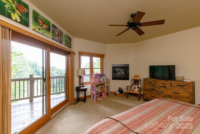 bedroom with access to exterior, ceiling fan, and carpet