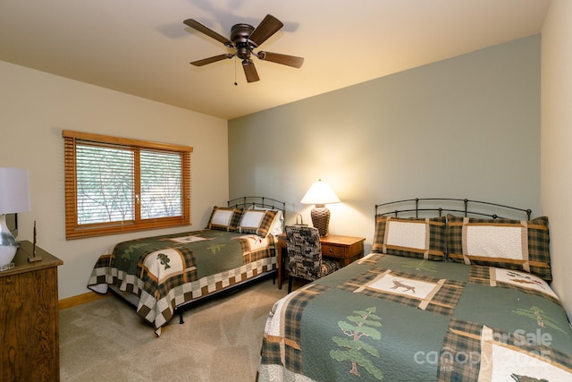 carpeted bedroom with baseboards and a ceiling fan
