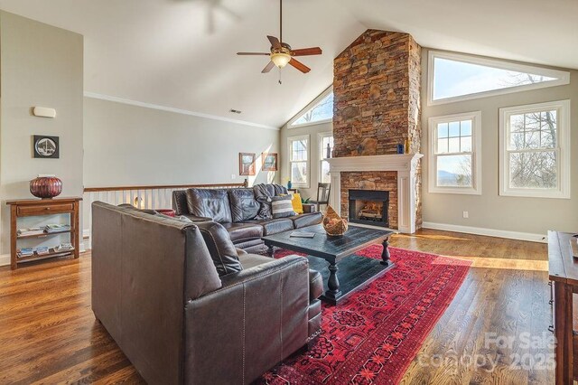 61 Buckle Rdg, Weaverville, NC 28787 - living room featuring ceiling fan, wood finished floors, a stone fireplace, high vaulted ceiling, and baseboards