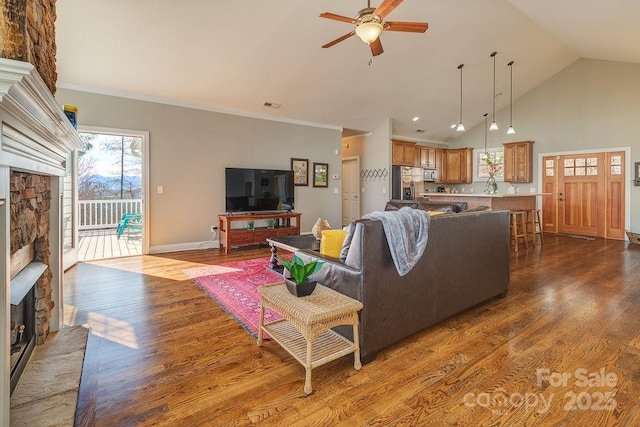 61 Buckle Rdg, Weaverville, NC 28787 - living room with a fireplace, ceiling fan, dark wood-type flooring, baseboards, and high vaulted ceiling