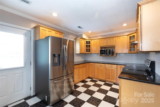 kitchen featuring appliances with stainless steel finishes, dark flooring, light brown cabinets, recessed lighting, and glass insert cabinets