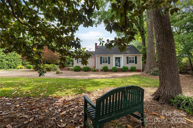 view of front of house featuring a front yard and a chimney