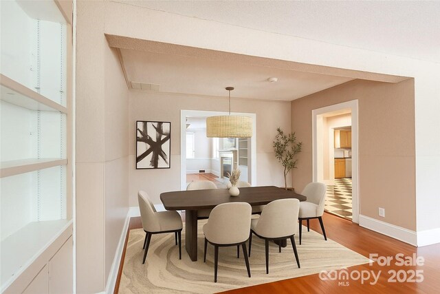 539 Marsh Rd, Charlotte, NC 28209 - dining space featuring wood finished floors and baseboards