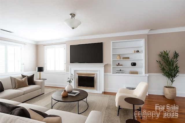 539 Marsh Rd, Charlotte, NC 28209 - living area featuring wood finished floors, built in features, a fireplace, and crown molding