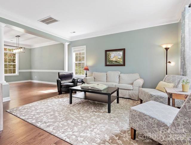 14220 Stewarts Bend Ln, Charlotte, NC 28277 - living room featuring a wealth of natural light, decorative columns, wood finished floors, and visible vents