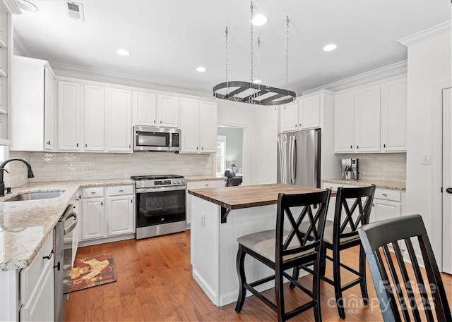 14220 Stewarts Bend Ln, Charlotte, NC 28277 - kitchen with visible vents, a sink, white cabinetry, and appliances with stainless steel finishes