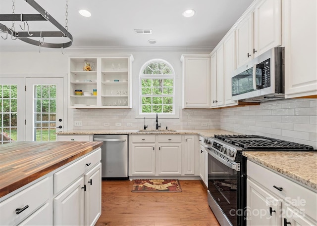 14220 Stewarts Bend Ln, Charlotte, NC 28277 - kitchen with visible vents, light wood-style floors, a sink, wood counters, and appliances with stainless steel finishes