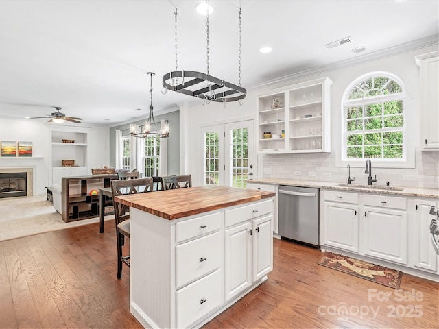 14220 Stewarts Bend Ln, Charlotte, NC 28277 - kitchen with stainless steel dishwasher, ornamental molding, wooden counters, a kitchen breakfast bar, and a sink