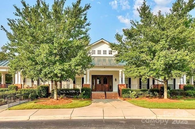 14220 Stewarts Bend Ln, Charlotte, NC 28277 - view of front of property featuring covered porch, fence, metal roof, and a standing seam roof