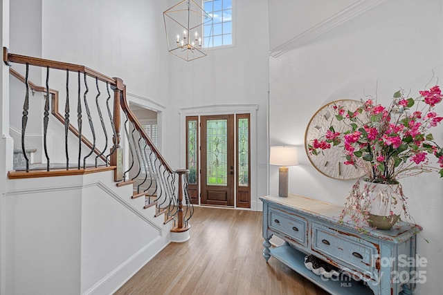 17040 Jetton Rd, Cornelius, NC 28031 - foyer entrance featuring a chandelier, wood finished floors, stairs, a towering ceiling, and baseboards