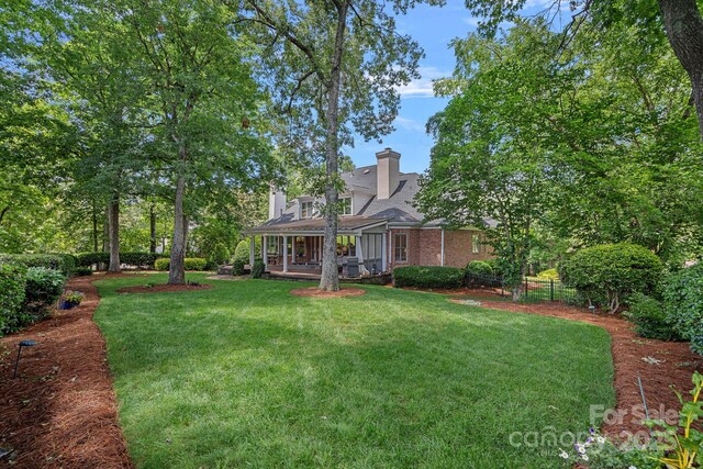 17040 Jetton Rd, Cornelius, NC 28031 - view of front of property featuring a front lawn, a chimney, a porch, and brick siding