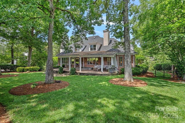 17040 Jetton Rd, Cornelius, NC 28031 - view of front of home featuring a chimney, brick siding, and a patio