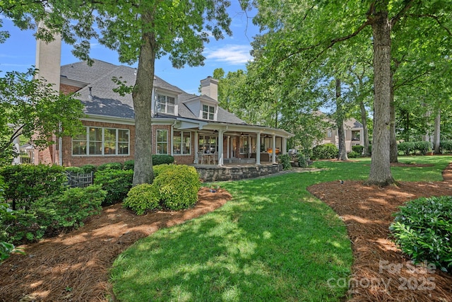 17040 Jetton Rd, Cornelius, NC 28031 - rear view of house with a chimney, a lawn, brick siding, and a shingled roof