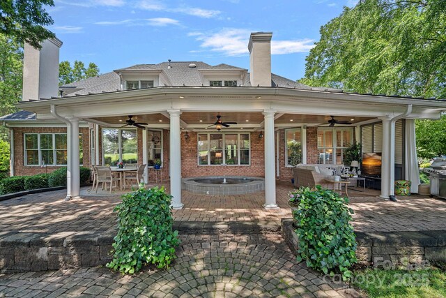 17040 Jetton Rd, Cornelius, NC 28031 - rear view of property featuring a chimney, ceiling fan, a patio, and brick siding