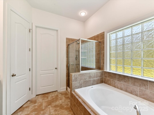 full bathroom featuring a stall shower and a bath