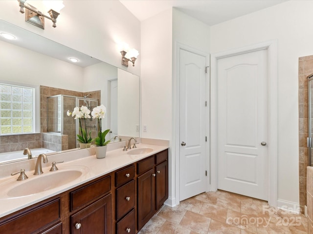 full bath featuring double vanity, a sink, and a stall shower