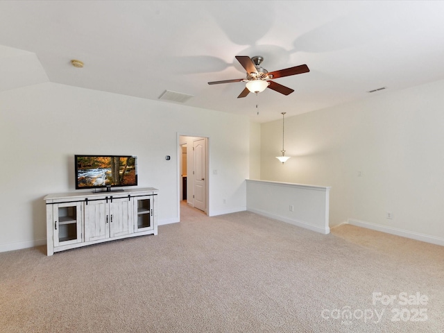 unfurnished living room featuring baseboards, a ceiling fan, and light colored carpet