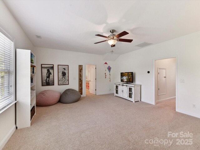 sitting room with light colored carpet, ceiling fan, visible vents, and baseboards