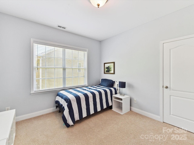 carpeted bedroom with baseboards, visible vents, and multiple windows