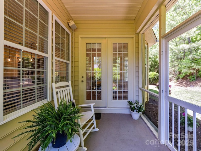 unfurnished sunroom with french doors