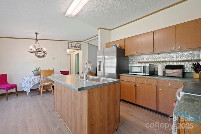 6282 Lor Rd, Morganton, NC 28655 - kitchen with stainless steel appliances, ornamental molding, a sink, light wood-type flooring, and a textured ceiling