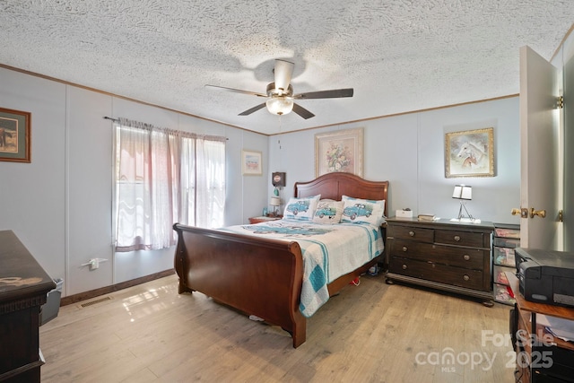 6282 Lor Rd, Morganton, NC 28655 - bedroom with light wood-style floors, visible vents, a textured ceiling, and ornamental molding