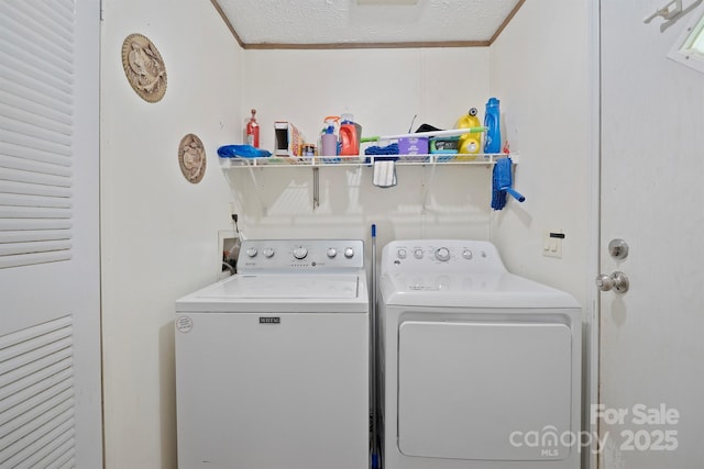 6282 Lor Rd, Morganton, NC 28655 - washroom with washing machine and dryer, a textured ceiling, ornamental molding, and laundry area