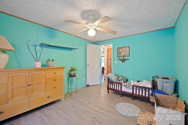 6282 Lor Rd, Morganton, NC 28655 - bedroom featuring light wood-style flooring, a textured ceiling, and ceiling fan