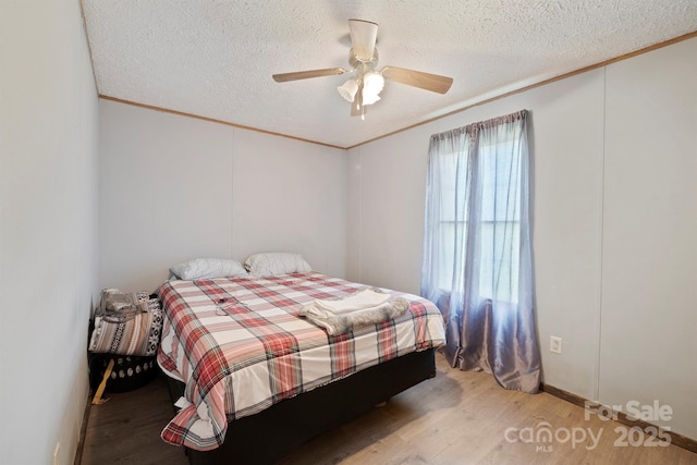 6282 Lor Rd, Morganton, NC 28655 - bedroom featuring wood finished floors, a textured ceiling, and crown molding
