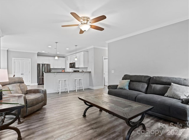 10340 Williams Rd, Mint Hill, NC 28227 - living area featuring ceiling fan, crown molding, baseboards, recessed lighting, and wood finished floors