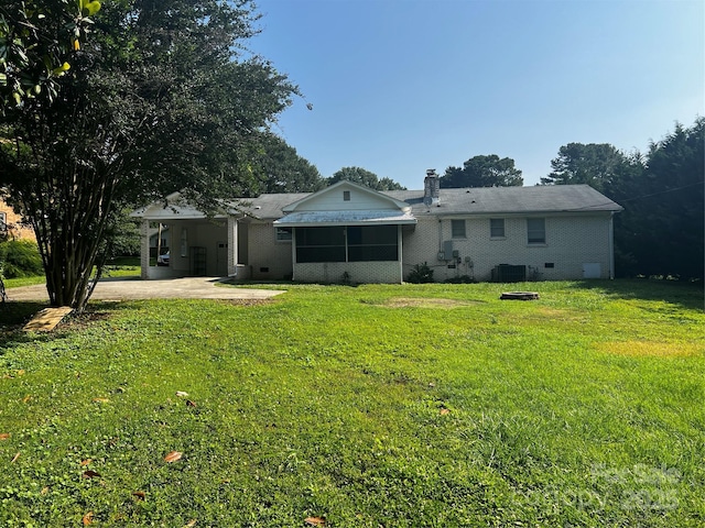 629 Belmorrow Dr, Charlotte, NC 28214 - back of property with a yard, central AC, a chimney, an attached carport, and driveway