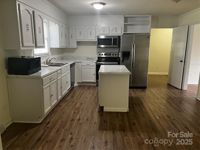 629 Belmorrow Dr, Charlotte, NC 28214 - kitchen featuring appliances with stainless steel finishes, a sink, ornamental molding, a center island, and light countertops