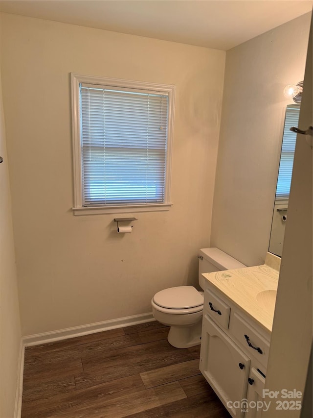 629 Belmorrow Dr, Charlotte, NC 28214 - half bathroom with toilet, wood finished floors, vanity, and baseboards