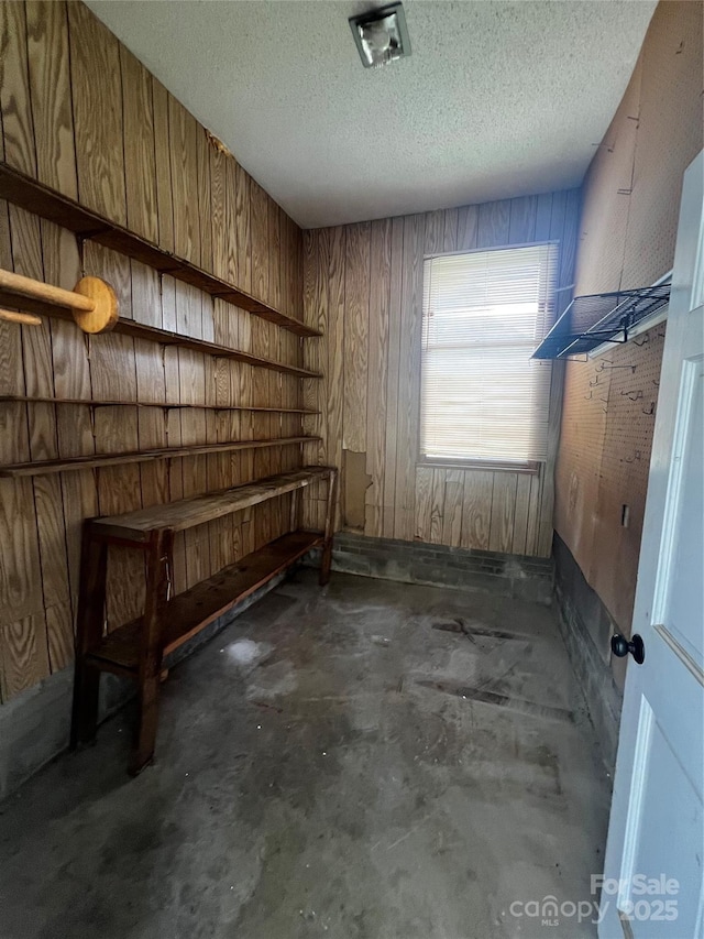 629 Belmorrow Dr, Charlotte, NC 28214 - unfurnished bedroom with concrete flooring, wooden walls, and a textured ceiling