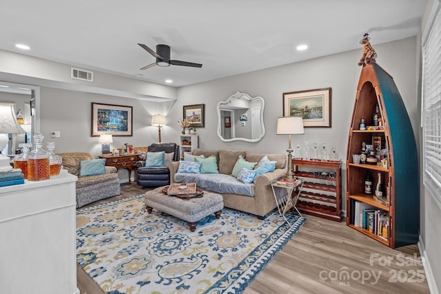 living room featuring visible vents, ceiling fan, recessed lighting, and wood finished floors