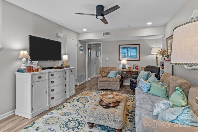 living room featuring wood finished floors, a ceiling fan, visible vents, and recessed lighting