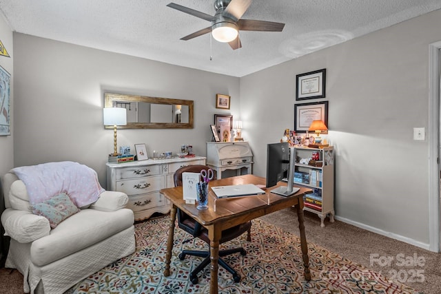 carpeted office space with baseboards, a ceiling fan, and a textured ceiling