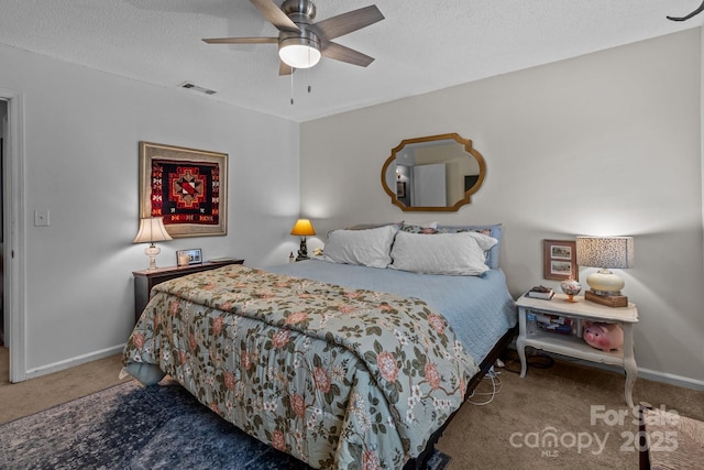bedroom featuring ceiling fan, carpet, a textured ceiling, visible vents, and baseboards