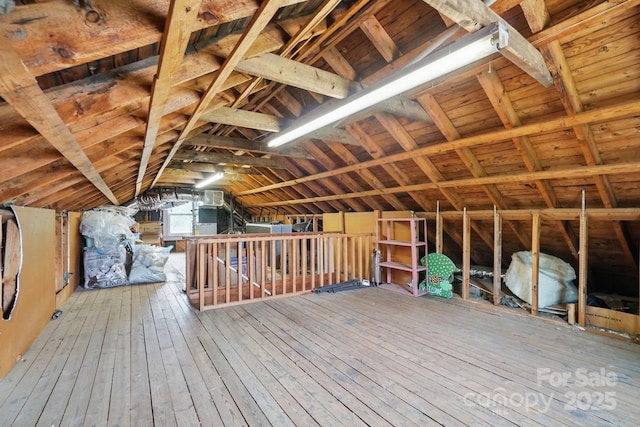 unfinished attic with an upstairs landing