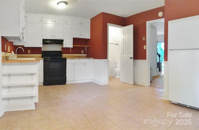 kitchen featuring freestanding refrigerator, open shelves, under cabinet range hood, white cabinets, and black range with electric stovetop