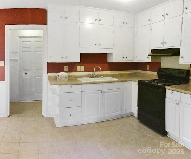kitchen with a sink, electric range, under cabinet range hood, and white cabinets